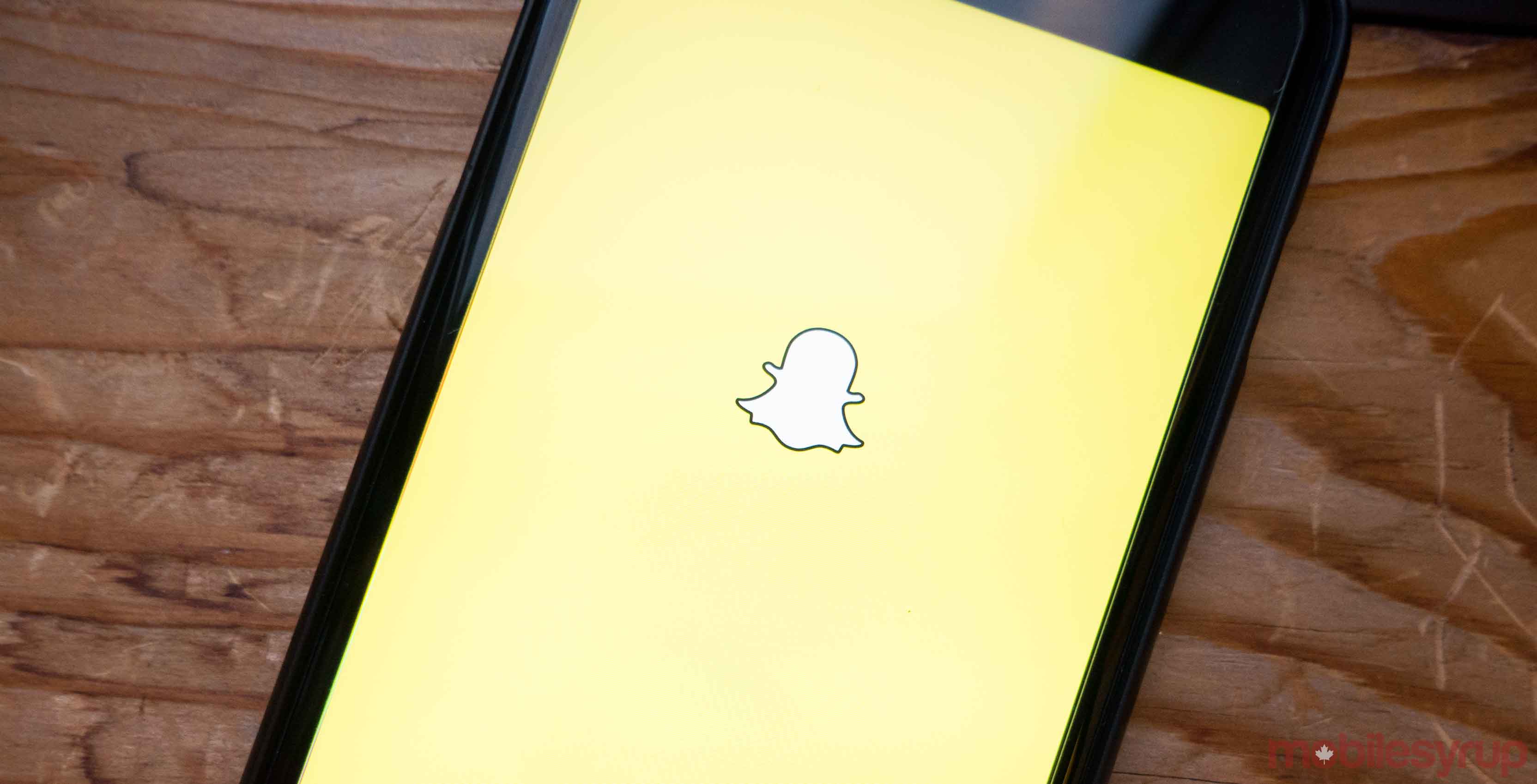 snapchat logo on mobile phone - snapchat makeup lens