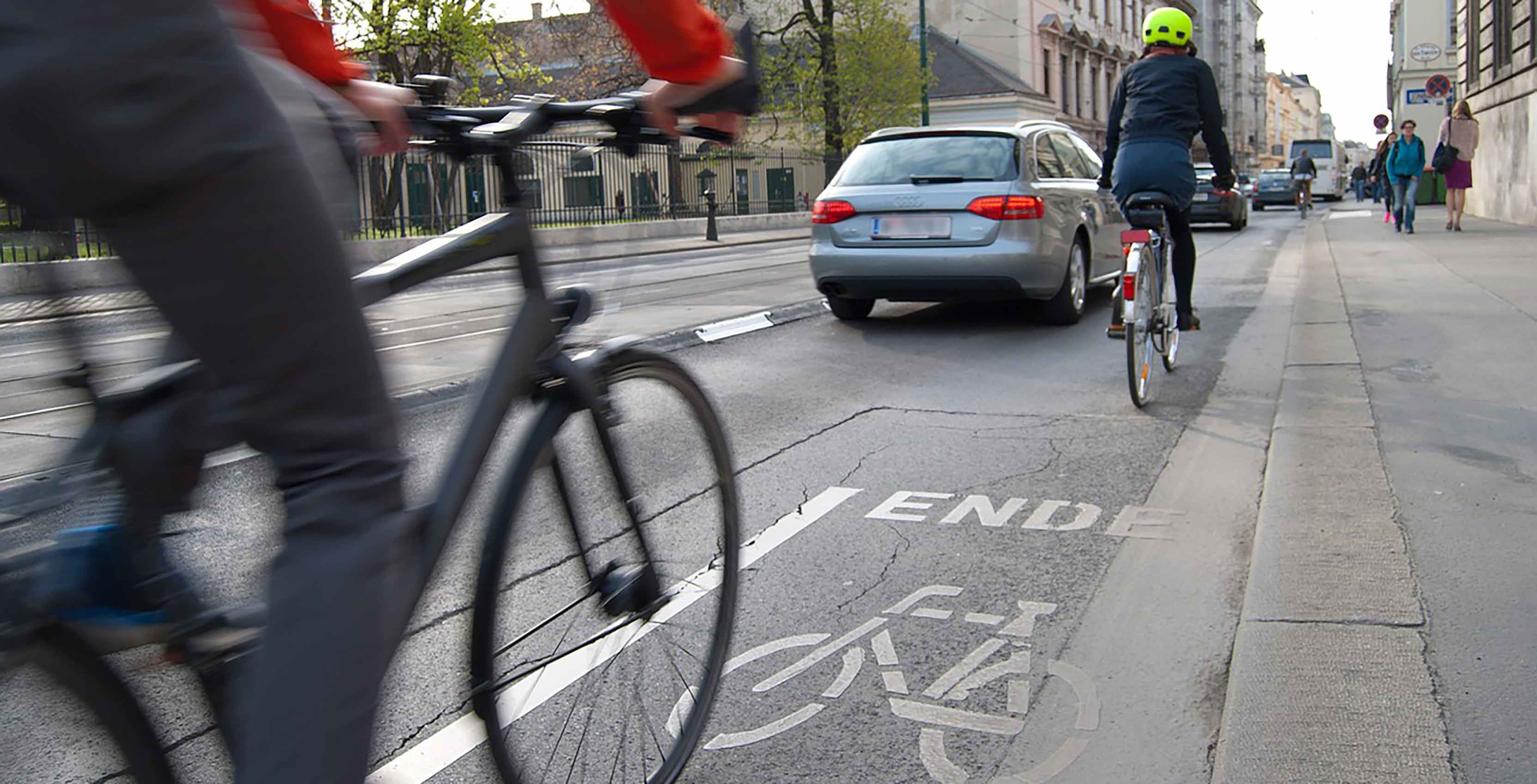 Bicycles on bike path near car