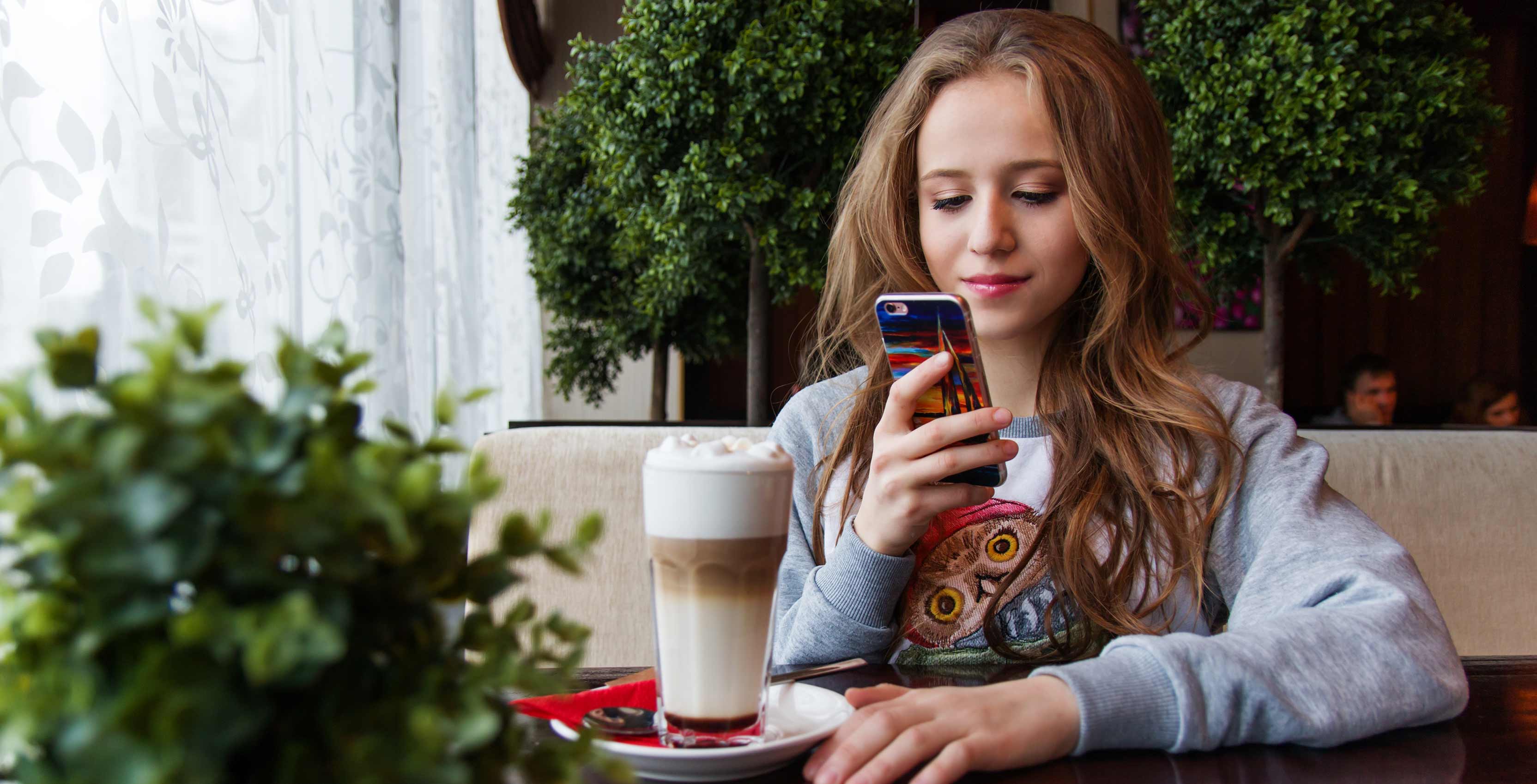 woman using phone in restaurant