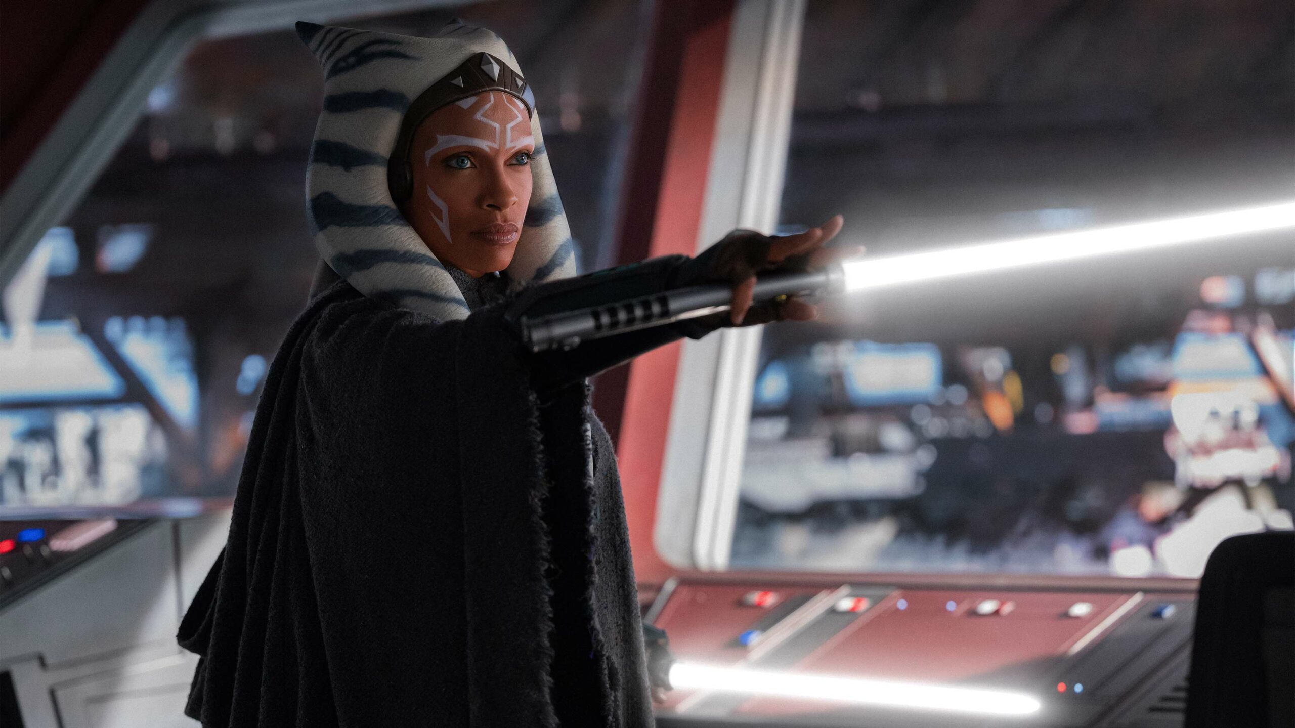 Rosario Dawson holding a lightsaber as Ahsoka in the Ahsoka series.