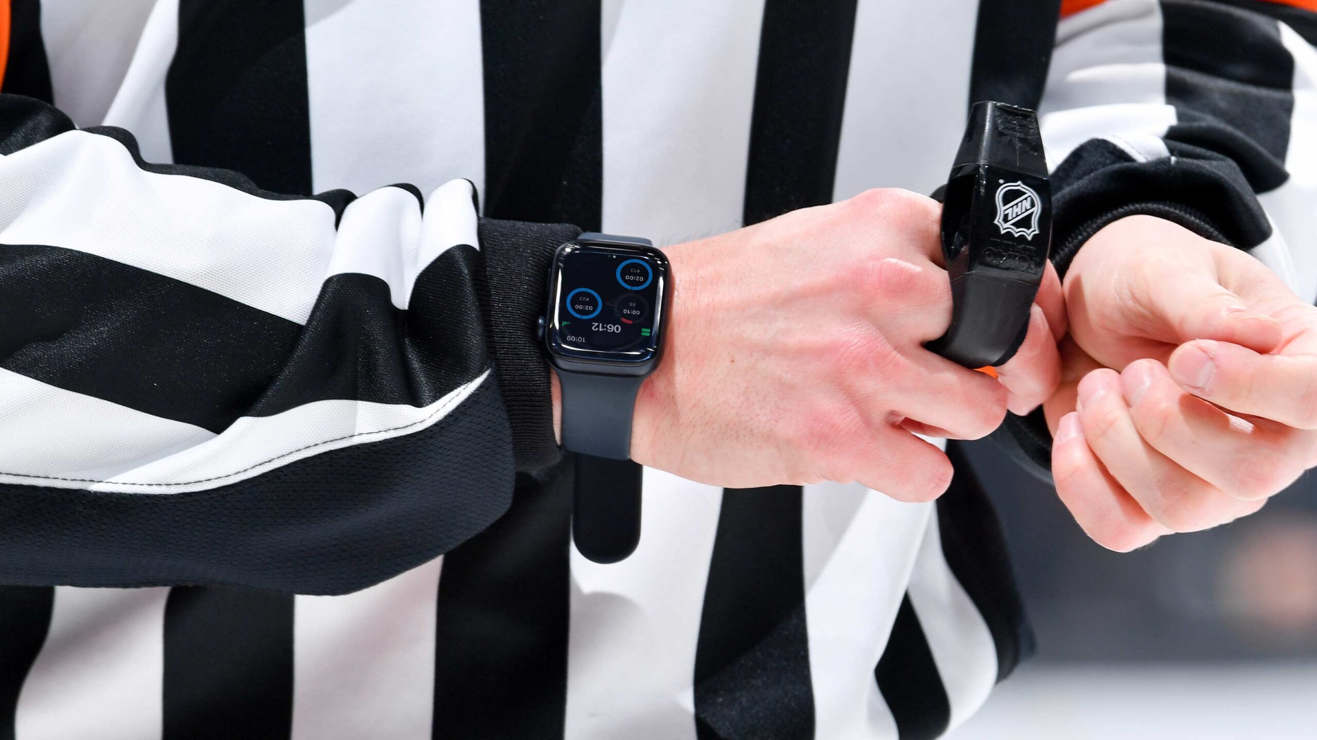 An NHL referee wearing an Apple Watch