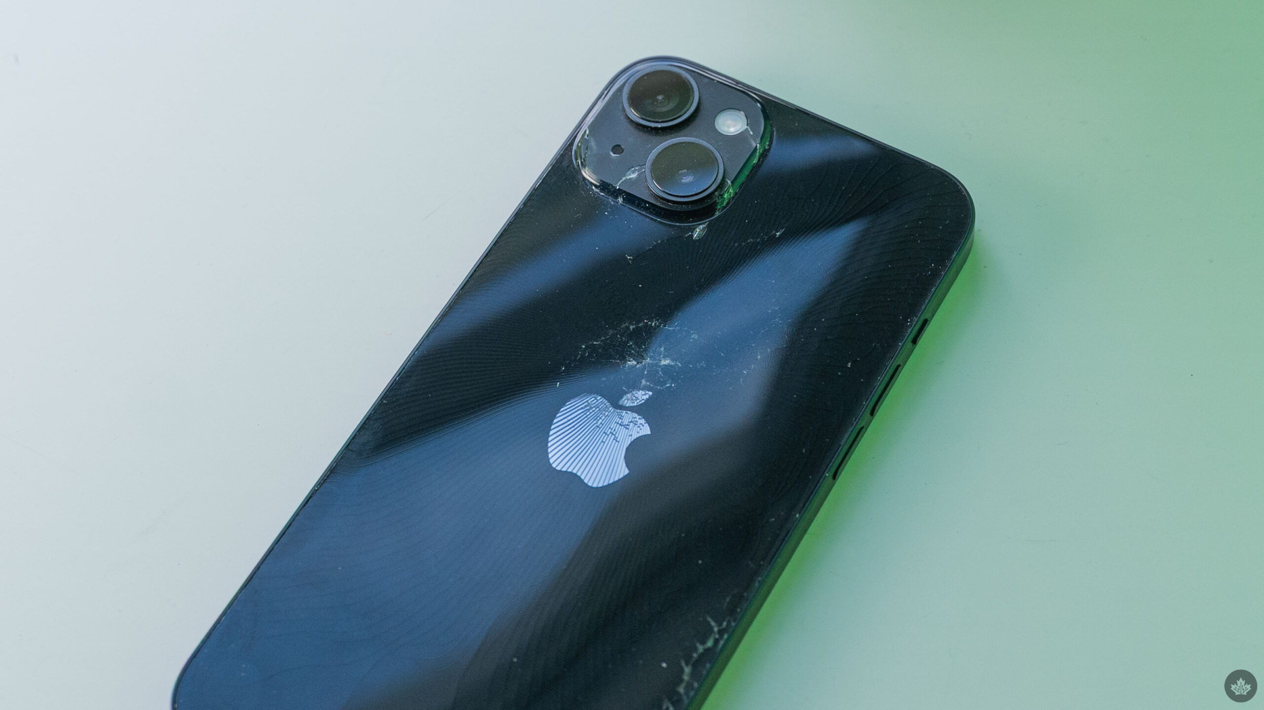 Apple iPhone with broken rear glass.