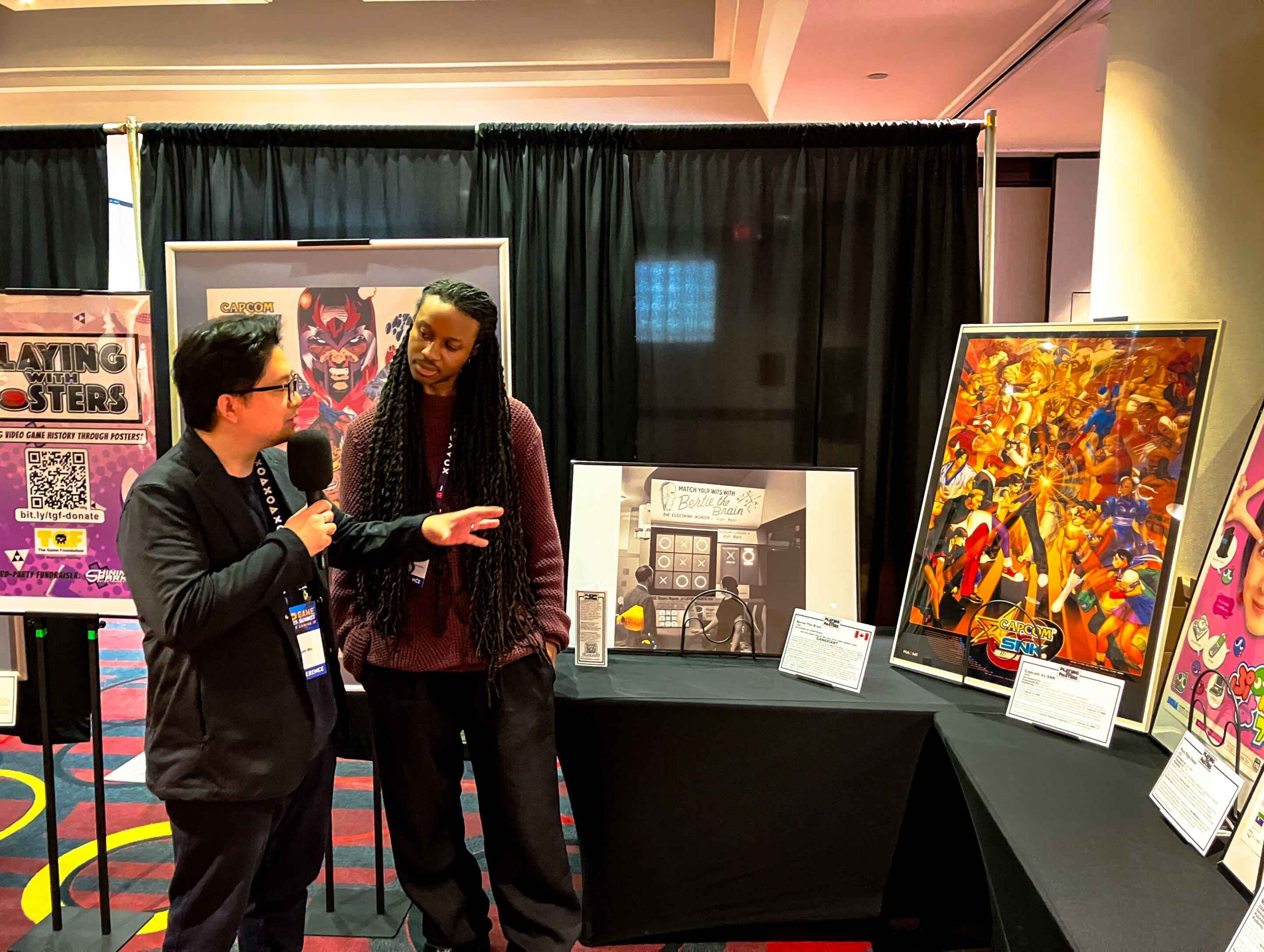 Playing With Posters Dixon Wu talking with attendee