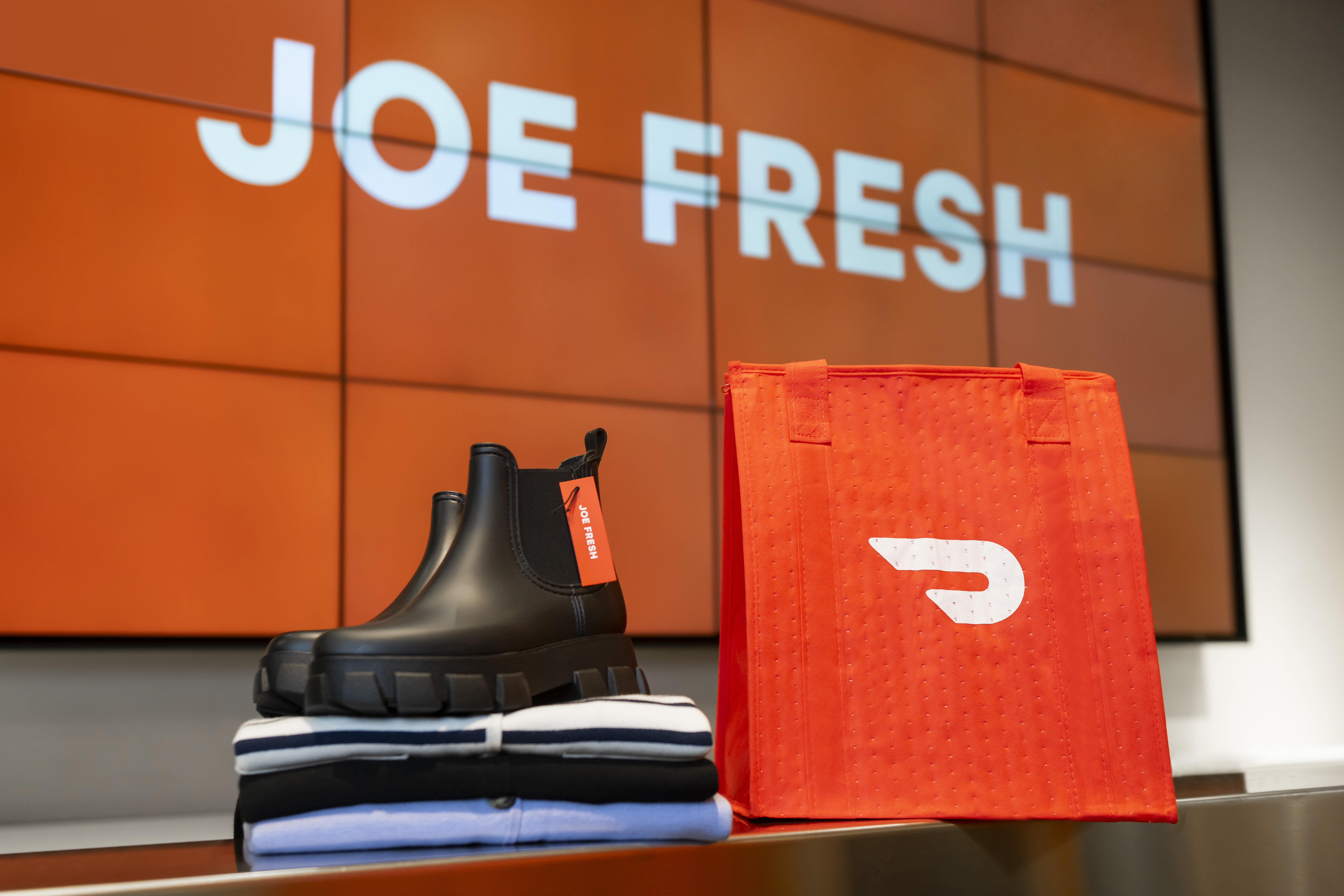 DoorDash bag next to a Joe Fresh boot