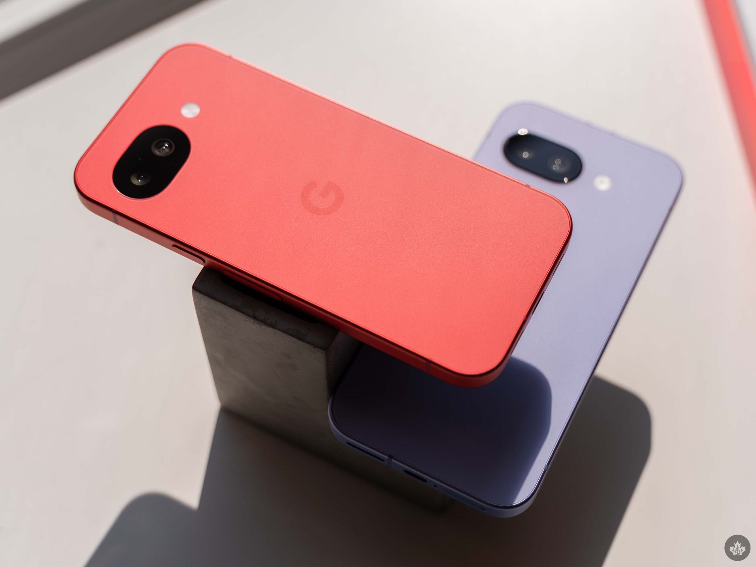 Pixel 10a (left, red) and Pixel 9a (right, lavendar).