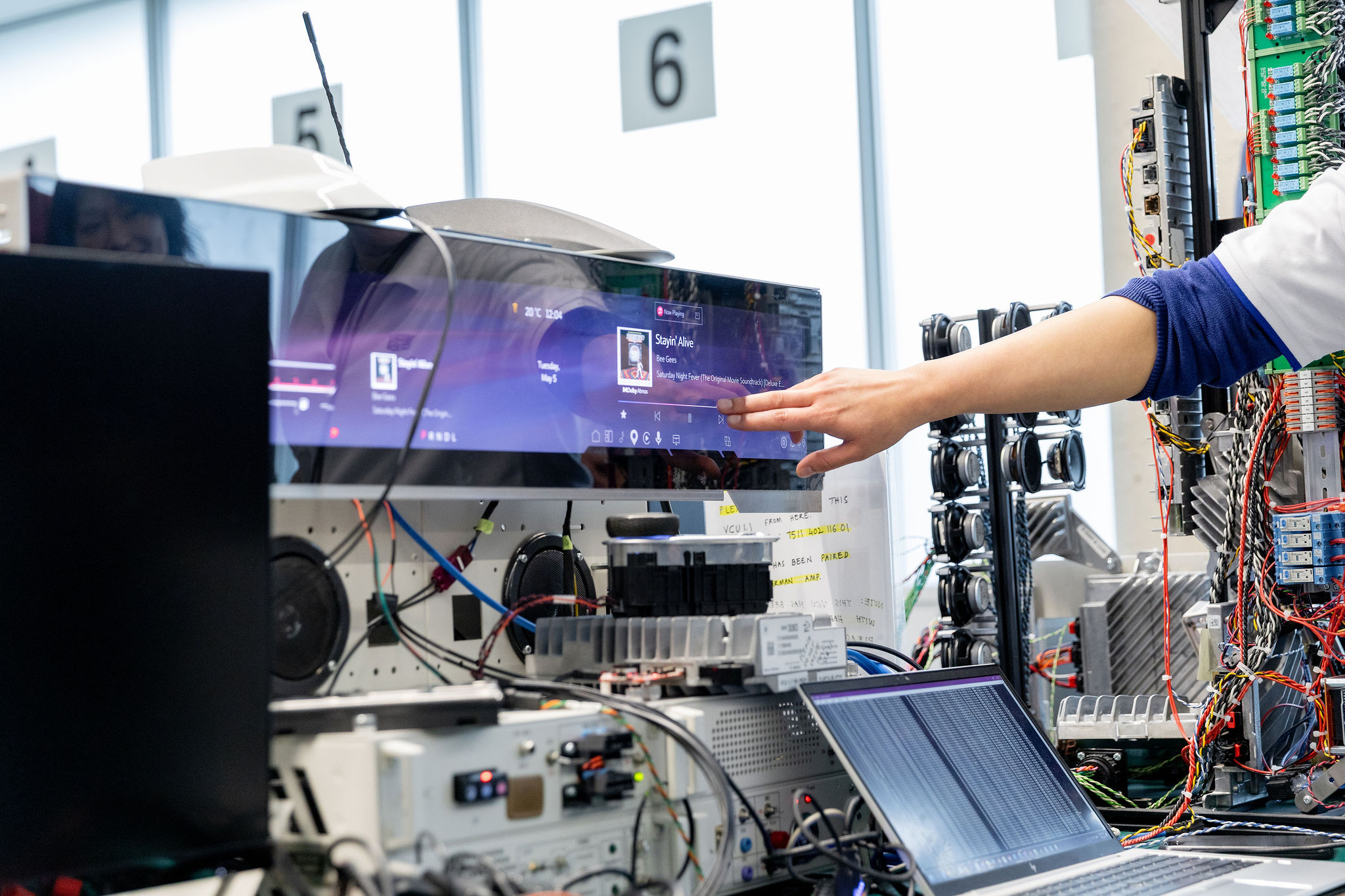 An engineer pointing to an infotainnment screen in the General Motors Markham Elevation Centre
