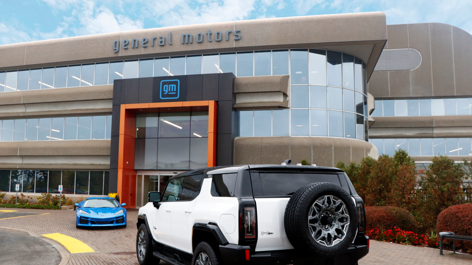 A White GMC Hummer and a blue Chevrolet Corvette parked outside the Markham Elevation Centre